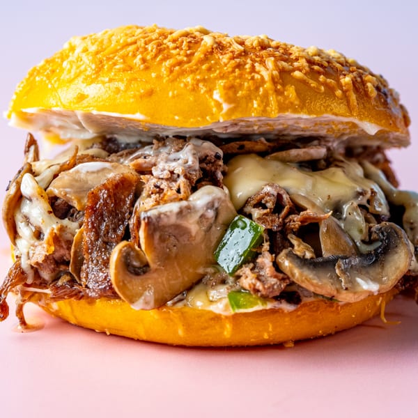 Cheesesteak bagel from Beverly Hills Bagel, filled with steak, mushrooms, green peppers, and melted cheese.